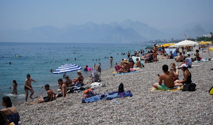 Sıcaklık 37 dereceyi buldu: Antalya sahilleri doldu taştı